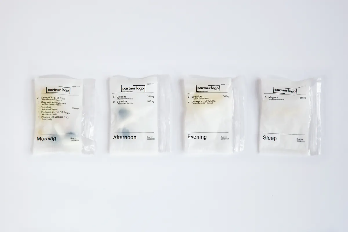 Four packs for one day, marked morning, afternoon, evening and sleep, each printed with a practice's own logo